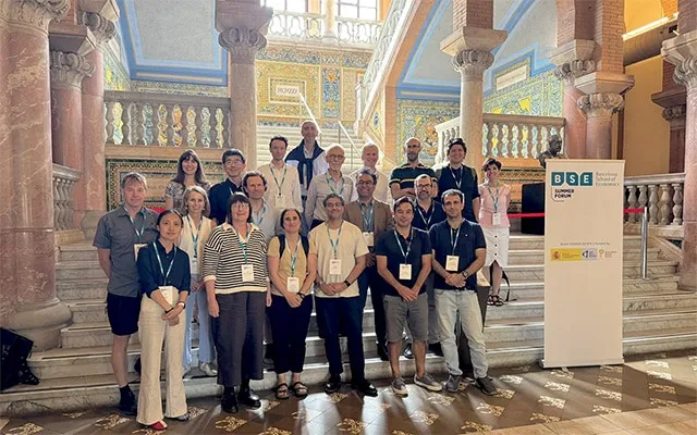 group photo of researchers on the stairs inside Casa Convalescència