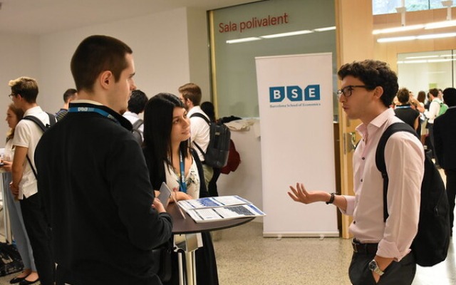 Students talking in bright room at careers fair at Barcelona School of Economics Students talking in bright room at careers fair at Barcelona School of Economics