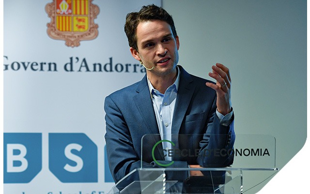 Ben Golub speaks at a podium during the Prize lecture in Barcelona