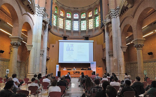Barcelona School of Economics research events Research roundtable in a Modernist room with vaulted ceiling and stained glass windows