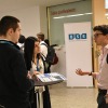 Students talking in bright room at careers fair at Barcelona School of Economics