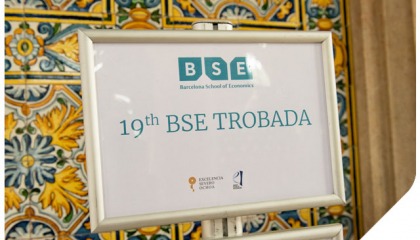 19th Barcelona School of Economics Trobada A sign directing participants next to brightly colored wall tiles
